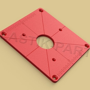 May include: Red square router template with a large center hole and several smaller holes around the perimeter. The template has a ruler on two sides.