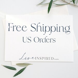 May include: White card with the text "Free Shipping US Orders" in dark blue. The text "Live Inspired Studios" is in a cursive font in dark blue at the bottom of the card.