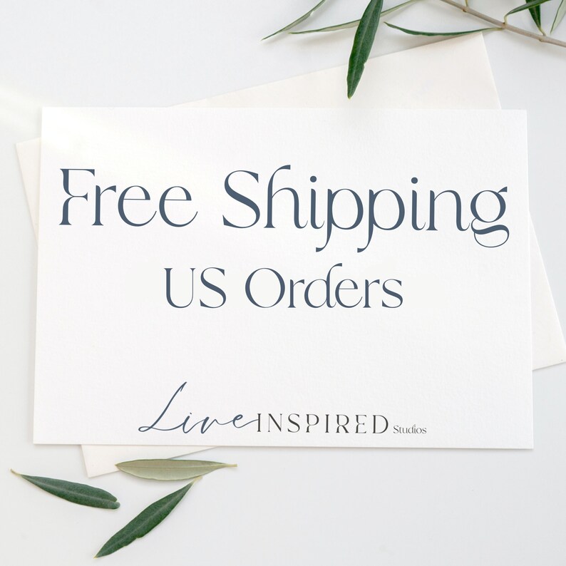May include: White card with the text "Free Shipping US Orders" in dark blue. The text "Live Inspired Studios" is in a cursive font in dark blue at the bottom of the card.