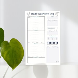 May include: A printable daily nutrition log with sections for breakfast, lunch, dinner, and snacks. It includes space to track calories, protein, carbs, fat, hours of sleep, daily gratitude, medication or supplements, water intake, and physical activity.