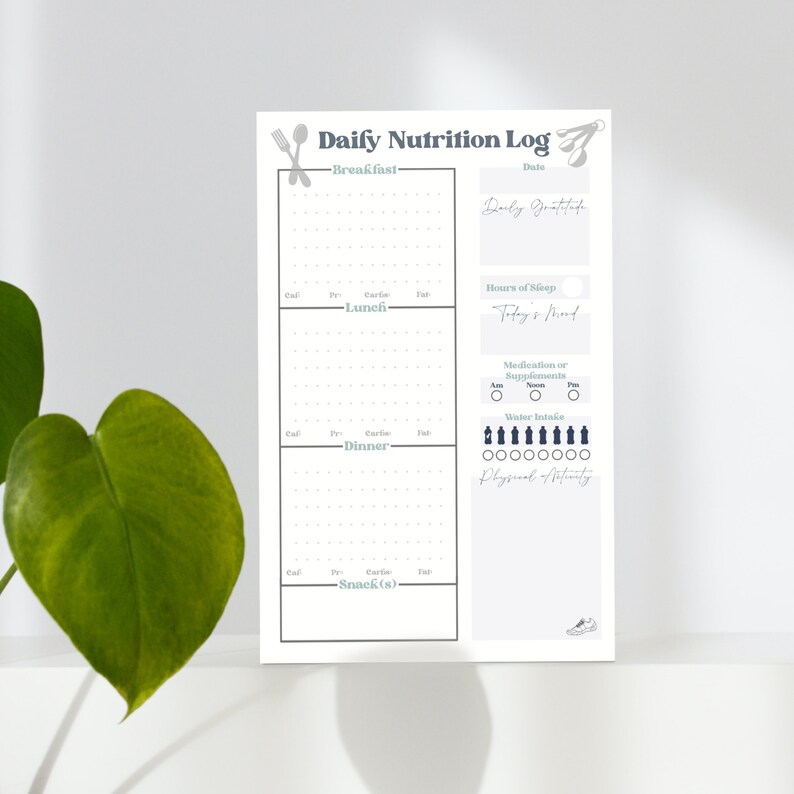 May include: A printable daily nutrition log with sections for breakfast, lunch, dinner, and snacks. It includes space to track calories, protein, carbs, fat, hours of sleep, daily gratitude, medication or supplements, water intake, and physical activity.