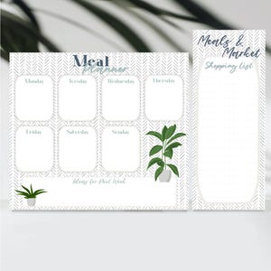 May include: A white and gray meal planner and shopping list set. The meal planner has spaces for each day of the week, with the text "Meal Planner" at the top. The shopping list is dotted.