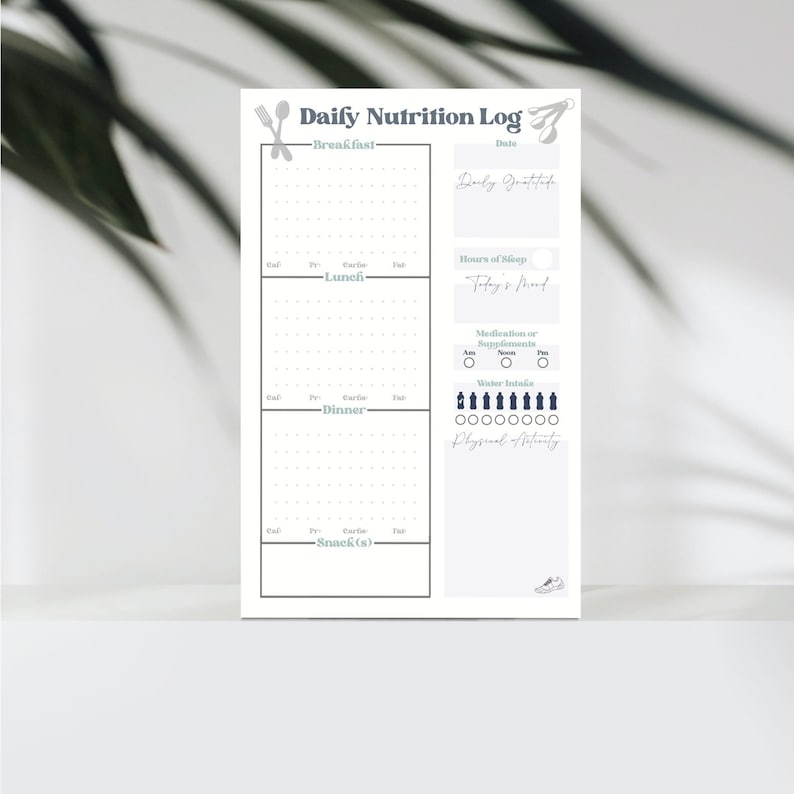 May include: A printable daily nutrition log with sections for breakfast, lunch, dinner, snacks, daily gratitude, hours of sleep, today's mood, medication or supplements, water intake, and physical activity. The log is designed to help people track their food intake and physical activity.