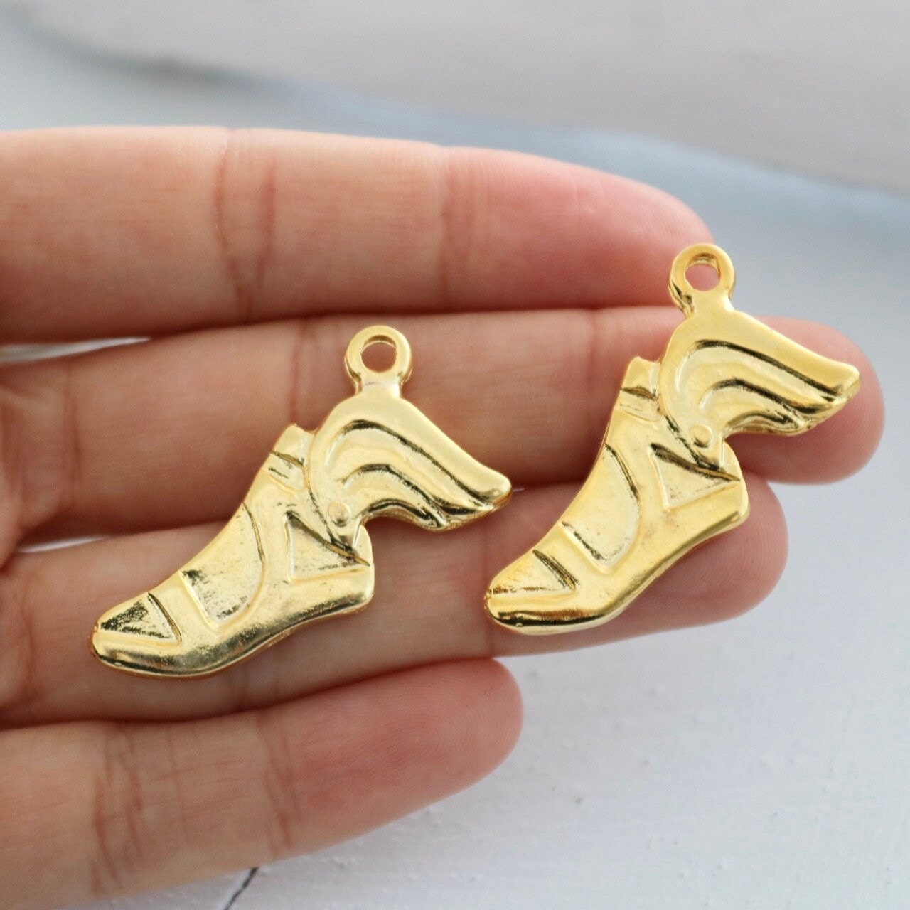 gold trainers with wings