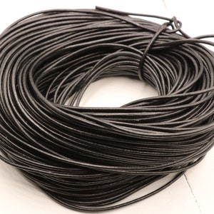 May include: A coil of black leather cord, perfect for crafting jewelry, keychains, or other leather projects.