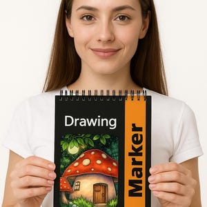 May include: A spiral-bound drawing pad with a black cover and an orange vertical stripe. The cover features the word "Drawing" and a colorful illustration of a mushroom house. The pad is labeled "Marker Paper" with dimensions of 5.48 x 5.57 inches.