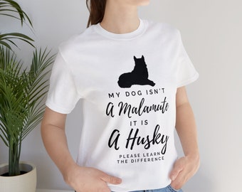 May include: White t-shirt with a black silhouette of a husky dog and the text "My dog isn't a Malamute it is a Husky Please learn the difference."