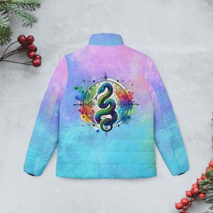 May include: A blue and pink tie-dye puffer jacket with a colourful snake design in a circle on the back. The snake is surrounded by a watercolour effect.