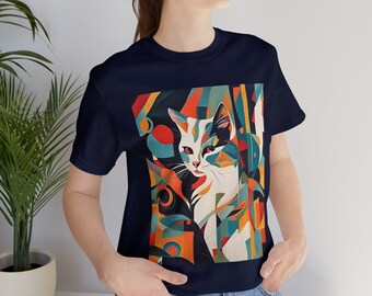 May include: A navy blue t-shirt with a colorful abstract design featuring a white cat with black and orange markings. The design is geometric and includes a variety of shapes and colors.