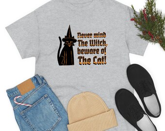 May include: A gray t-shirt with a black cat wearing a witch's hat. The text on the shirt reads "Never mind The Witch, beware of The Cat!"