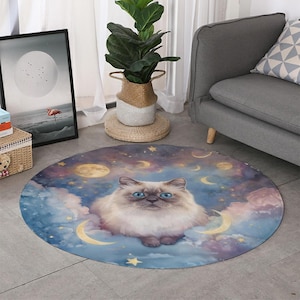 May include: Round area rug featuring a fluffy cat with blue eyes, set against a dreamy backdrop of clouds, moons, and stars. The rug's color palette includes blues, purples, and golds, creating a whimsical and celestial theme.