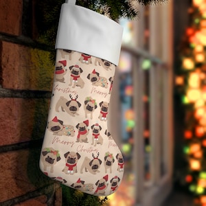 May include: Christmas stocking with a cream background featuring illustrations of pugs wearing festive accessories like Santa hats and scarves. The words "Merry Christmas" are printed in a script font.