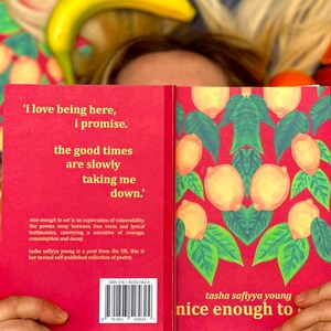 May include: A red book with the title "nice enough to eat" by tasha safiyya young. The cover features a lemon pattern and the text "'i love being here, i promise. the good times are slowly taking me down.'"