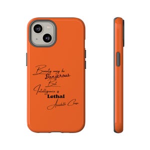 May include: Orange phone case with a black quote that reads "Beauty may be dangerous but intelligence is lethal" and the name "Annabeth Chase" in cursive.