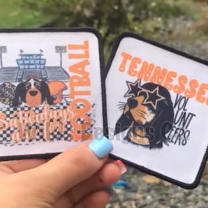 May include: Two square patches with black borders. One features a football stadium, football, helmet, and a dog with the text "FOOTBALL Saturdays in the South". The other says "TENNESSEE VOLUNTEERS" with a dog wearing star-shaped sunglasses.