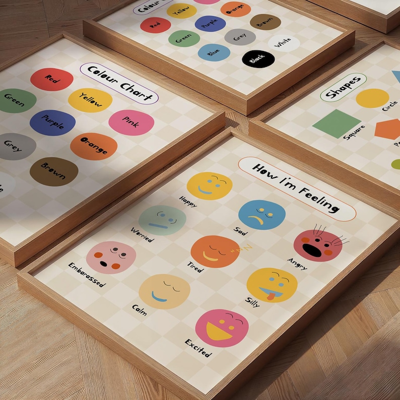 May include: A set of framed educational prints with wooden frames. The prints display colour charts, shape charts, and an "How I'm Feeling" chart. The colour charts show colour names with matching coloured circles.