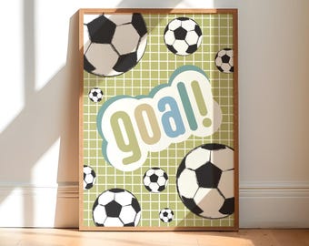 May include: A framed print with a green and white grid background. The print features a large white cloud with the word "goal!" in colorful letters. There are multiple black and white soccer balls scattered throughout the print.