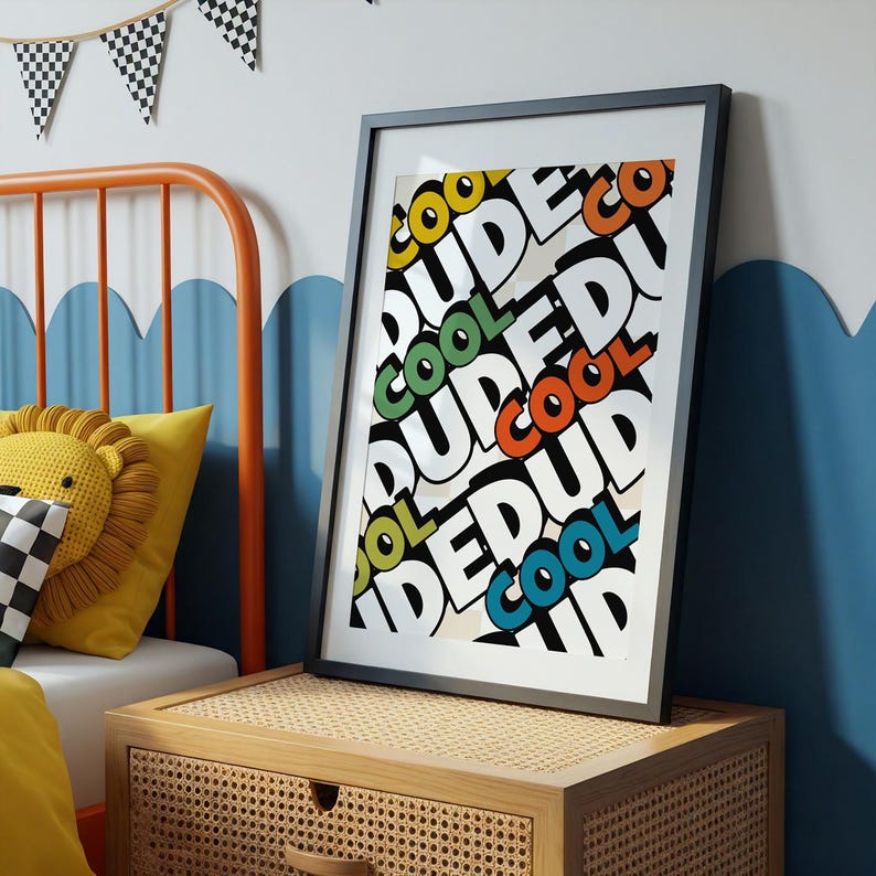 May include: A framed art print with the words "COOL DUDE" in a repeating pattern. The text is in various colors, including yellow, green, orange, and blue, against a white background. The frame is black. The print is displayed on a wooden nightstand.