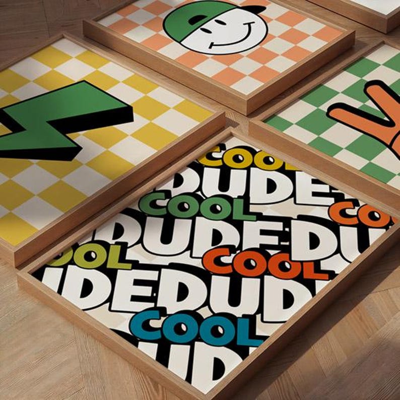 May include: A collection of framed art prints with a retro, pop art aesthetic. The prints feature bold graphics like a green lightning bolt, a smiley face wearing a cap, and the word "DUDE" in a colorful, comic book style. The backgrounds have checkered patterns.