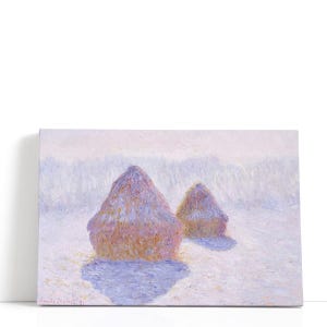 May include: Canvas print of a landscape painting featuring two haystacks in a field. The haystacks are painted in shades of pink, purple, and yellow, with long shadows. The background is a soft, hazy blend of white and pink.