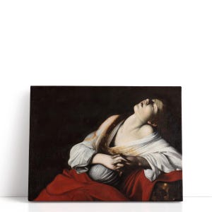 May include: A canvas print of a classical painting depicting a woman with her head tilted back and eyes closed. She is wearing a white garment with red fabric draped around her. The background is dark.