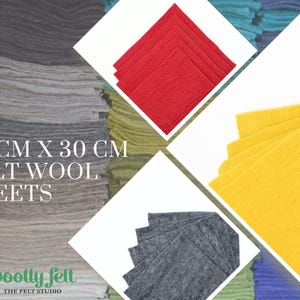 May include: Stacks of felt wool sheets in various colors, including gray, red, and yellow. Each sheet measures 30 cm x 30 cm. The image also features the logo for "Woolly Felt - The Felt Studio."