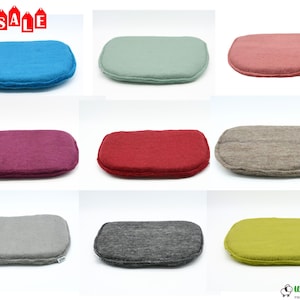 May include: A collection of nine rectangular felt cushions in various colors, including blue, green, pink, purple, red, gray, and yellow. The cushions have a rounded shape and are displayed against a white background. The word "SALE" is visible in the top left corner.