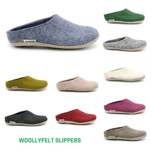 May include: A range of colours of wool felt slippers. The slippers are all made from wool felt and have a simple design. The slippers are displayed against a white background. WOOLLYFELT SLIPPERS is written in green text at the bottom of the image.