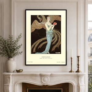 George Barbier Sortilèges fashion poster showing a woman in a pale blue evening gown with a large golden bird against a dark background.