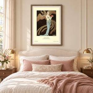 George Barbier Sortilèges fashion poster showing a woman in a pale blue evening gown with a large golden bird against a dark background.