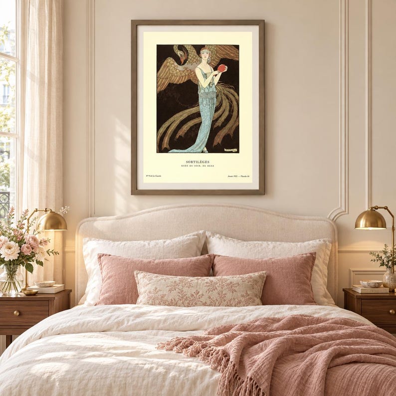 George Barbier Sortilèges fashion poster showing a woman in a pale blue evening gown with a large golden bird against a dark background.