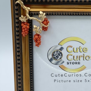 Bronze colored wooden photo frame with orange grape decoration