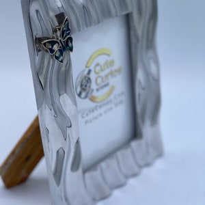 Heavy silver &#39;wave&#39; picture frame with butterfly &#39;brooch&#39; detail