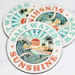 May include: Three round coasters with a beach theme. The coasters feature a sunset, waves, palm trees, and the text "Salt Water & Sunshine" in a retro font.