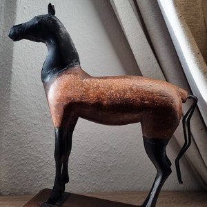 Sculpture of a horse made of wood and metal