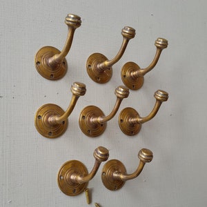 8 vintage style heavy cast brass Victorian design  coat hooks  in a AGED finish NOT lacquered or coated includes matching solid brass screws