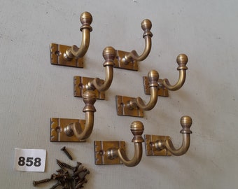 8 vintage style heavy cast brass Victorian design  coat hooks  in a AGED finish NOT lacquered or coated includes matching solid brass screws
