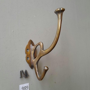 An Elegant vintage style solid brass arts & crafts coat hook in an aged finish NOT lacquered or coated includes FREE Matching brass screws
