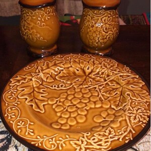 jumbo salt and pepper shakers plus 2 matching saucers grape/acorn design