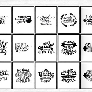 May include: A collection of framed black and white motivational posters. Each poster features a different fitness-related quote in a bold, stylized font. The quotes include phrases like "Don't care", "Adore your core", and "Squat until you walk funny."