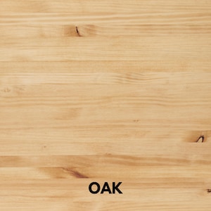 May include: Close-up of a light-colored oak wood surface. The wood grain is visible, with a mix of light and medium brown tones. The word "OAK" is printed in black at the bottom of the image.