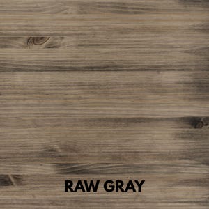 May include: A close-up of a wooden surface with a raw gray finish. The wood grain is visible, with horizontal lines and knots. The text "RAW GRAY" is printed in black at the bottom of the image.