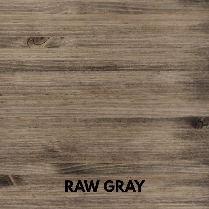 May include: A close-up of a wooden surface with a raw gray finish. The wood grain is visible, with horizontal lines and knots. The text "RAW GRAY" is printed in black at the bottom of the image.