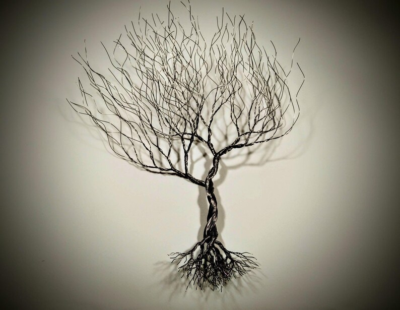 May include: A black wire sculpture of a tree with a twisted trunk and intricate branches. The tree is set against a white background.
