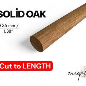 May include: A section of solid oak wood dowel, 1.38 inches in diameter, with the text "SOLID OAK" and "Cut to LENGTH". The wood has a natural grain and a light brown color. The image also includes a logo.