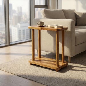 May include: A rectangular wooden side table featuring a smooth top surface, four cylindrical legs, and a lower shelf. The table is crafted from light brown wood with a visible grain pattern and rests on small, rounded feet at the base.