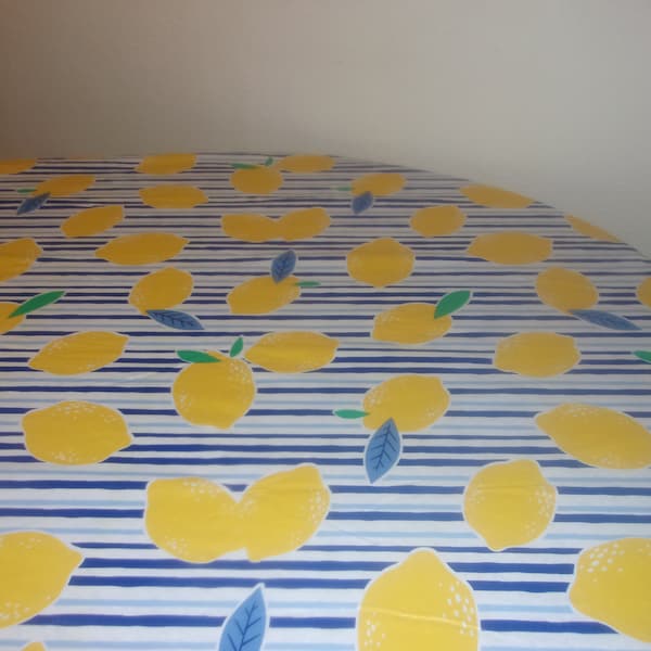 Fitted tablecloth. PEVA vinyl with felt backing 70 inch round to fit a 60 inch table .  Lemons and Blue Stripes