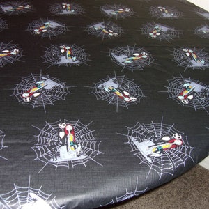 May include: Black and white round tablecloth with a repeating pattern of a spider web featuring Jack and Sally from The Nightmare Before Christmas.