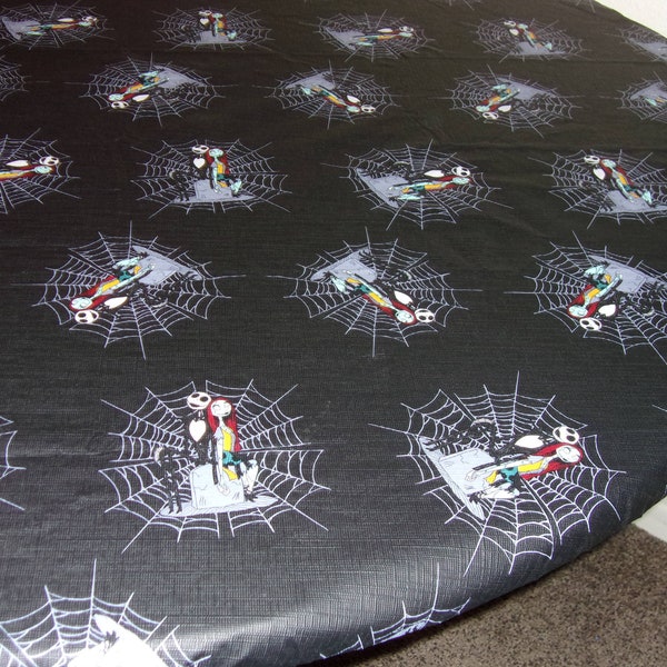 Fitted tablecloth. PEVA vinyl with felt backing 70 inch circle. Nightmare Before Christmas Black with Jack and Sally fis s 60" table