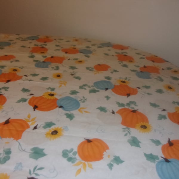 Fitted tablecloth. PEVA vinyl with felt backing 70 inch round to fit a 60 inch table . Botanic Pumpkins
